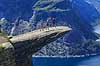 Trolltunga. Fjeldvandrer p� Trolltunga, en klippeformation der stikker ud af klippesiden 700 meter over Ringedalvatnet n�r Hardangervidda National Park  Trolltunga / Tyssedal Norge   Vandring, vandretur, fjeldvandring, turisme, hiking